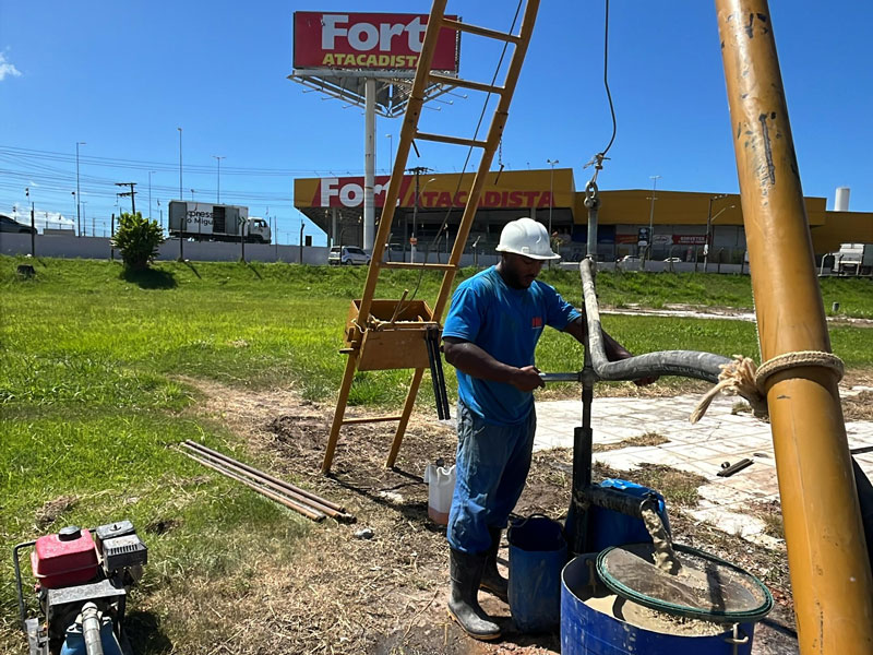 Técnico da IMS executando sondagem em terreno urbano, com equipamento de percussão